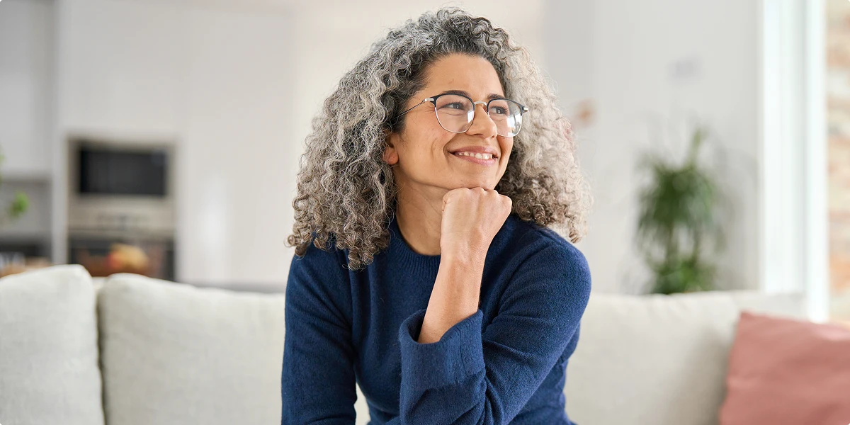 Midlife woman smiling confidently representing women’s health and healthy aging
