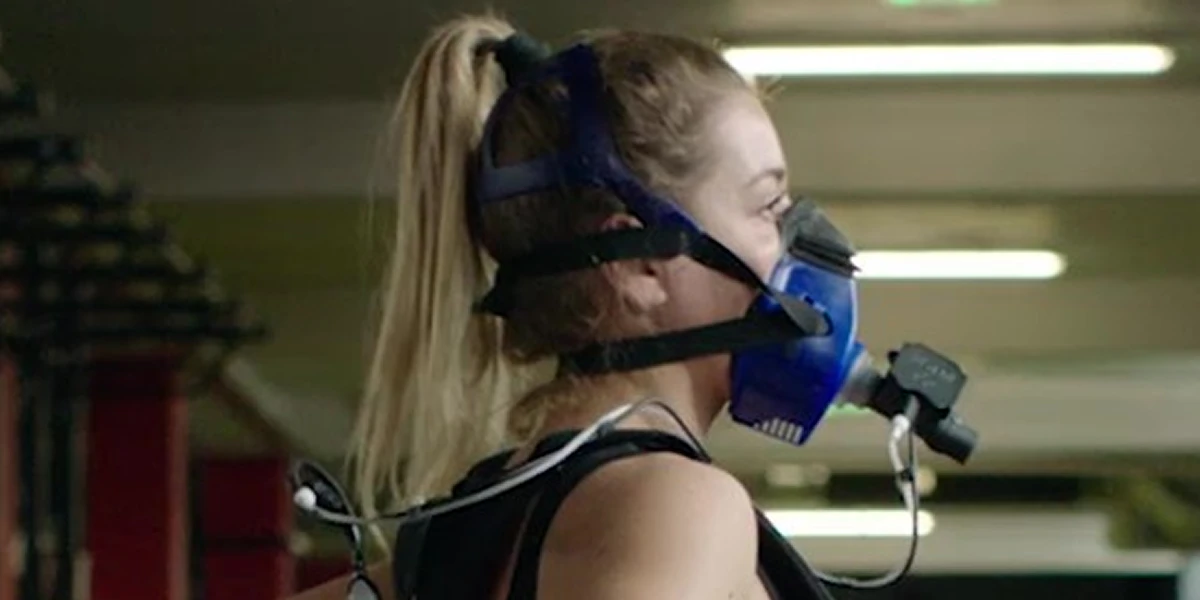 Woman performing VO2 max test with oxygen mask to measure cardio fitness and endurance performance