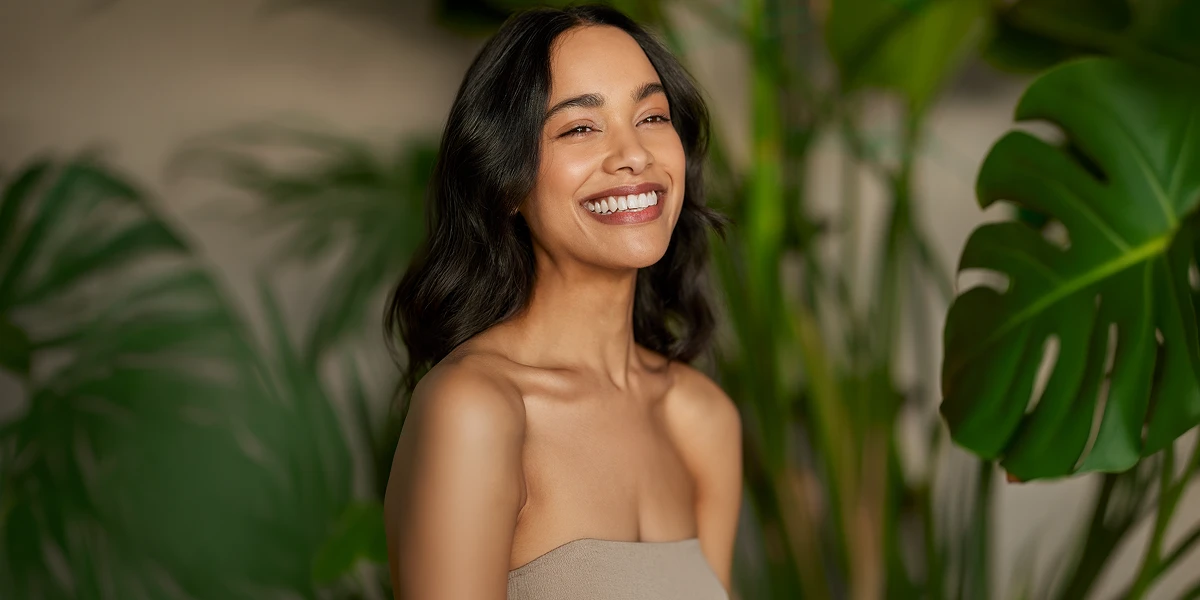 Woman highlighting the healthy aging and skin health benefits of glutathione IV therapy